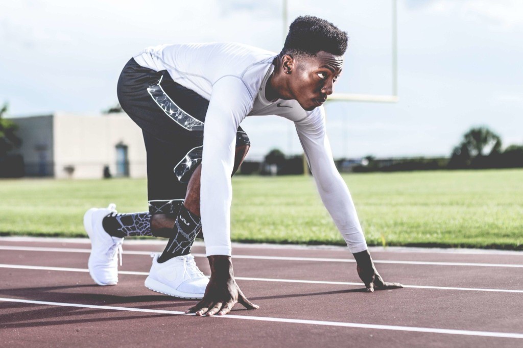 Athlete in a starting stance on the track